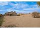 View of backyard from another angle, showing desert landscape at 2494 E Dulcinea Trl, Casa Grande, AZ 85194