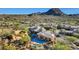 Aerial view of community with pool, clubhouse, and mountain backdrop at 27440 N Alma School Pkwy # 101, Scottsdale, AZ 85262