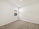 A bedroom with neutral walls and plush carpeting, bathed in natural light at 37028 W Prado St, Maricopa, AZ 85138