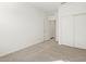 Bright bedroom featuring neutral carpeting, white walls, and a closet with sliding doors at 37028 W Prado St, Maricopa, AZ 85138