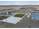 Aerial view of the community amenities featuring a playground, seating, and basketball and pickleball courts at 37028 W Prado St, Maricopa, AZ 85138