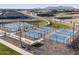 Aerial view of community pickleball courts and a playground at 37028 W Prado St, Maricopa, AZ 85138