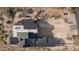 An aerial view of a modern home featuring a striking dark metal roof and desert landscaping at 40564 N 50Th St, Cave Creek, AZ 85331