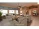 This virtually staged living room boasts neutral tones, contemporary furniture and natural light from the windows at 4889 S Nighthawk Dr, Gold Canyon, AZ 85118