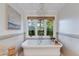 Relaxing bathroom with freestanding tub, chandelier, and large window at 6030 E Calle Del Sud St, Scottsdale, AZ 85251