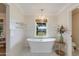 Charming bathroom with freestanding tub, subway tile, and window at 6030 E Calle Del Sud St, Scottsdale, AZ 85251