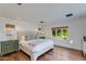 Main bedroom with a large bed, green dresser, and natural light at 6030 E Calle Del Sud St, Scottsdale, AZ 85251