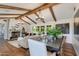 Elegant dining room with a large farmhouse table and rustic wooden beams at 6030 E Calle Del Sud St, Scottsdale, AZ 85251