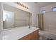 Bathroom with single sink vanity, bathtub, and shower at 10350 W Alvarado Rd, Avondale, AZ 85392