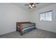 Bedroom with wooden daybed and ceiling fan at 10350 W Alvarado Rd, Avondale, AZ 85392