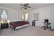 Bright bedroom with a ceiling fan and window coverings at 10350 W Alvarado Rd, Avondale, AZ 85392