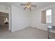 Bedroom with ceiling fan, closet, and home office area at 10350 W Alvarado Rd, Avondale, AZ 85392