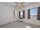 Bedroom with large windows, ceiling fan and a workspace at 10350 W Alvarado Rd, Avondale, AZ 85392