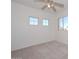 Bright bedroom with ceiling fan, new carpet, and large windows at 10350 W Alvarado Rd, Avondale, AZ 85392