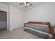 Bedroom with daybed, ceiling fan and sliding closet doors at 10350 W Alvarado Rd, Avondale, AZ 85392