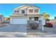 Two-story house with a white exterior, landscaping, and a two-car garage at 10350 W Alvarado Rd, Avondale, AZ 85392