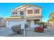 Two-story house with a white exterior, landscaping, and a two-car garage at 10350 W Alvarado Rd, Avondale, AZ 85392