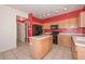 Kitchen boasts an island and wood cabinets at 10350 W Alvarado Rd, Avondale, AZ 85392