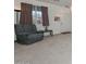 Living room with a recliner, carpet, and a view of the front door at 10350 W Alvarado Rd, Avondale, AZ 85392