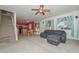 Living area with sectional sofa, stairs, and kitchen view at 10350 W Alvarado Rd, Avondale, AZ 85392