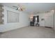 Living room with a recliner, carpet, and a view of the front door at 10350 W Alvarado Rd, Avondale, AZ 85392