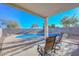 Relaxing covered patio overlooking the pool and backyard at 10350 W Alvarado Rd, Avondale, AZ 85392