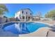 Beautiful blue pool in a sunny backyard with a two story house at 10350 W Alvarado Rd, Avondale, AZ 85392