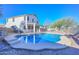 Inviting kidney-shaped pool with concrete decking and a covered patio at 10350 W Alvarado Rd, Avondale, AZ 85392