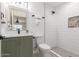 Clean bathroom with green vanity, white subway tile shower, and patterned floor at 1829 E Amelia Ave, Phoenix, AZ 85016