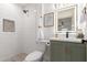 Modern bathroom with green vanity and white tile shower at 1829 E Amelia Ave, Phoenix, AZ 85016