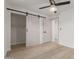 Bright bedroom with modern barn door and light wood flooring at 1829 E Amelia Ave, Phoenix, AZ 85016