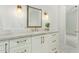 Elegant bathroom with a marble countertop, white cabinets, and gold fixtures at 2090 E Coconino Ct, Gilbert, AZ 85298