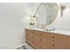 Bathroom boasts a large vanity with marble top and a frameless shower at 2090 E Coconino Ct, Gilbert, AZ 85298