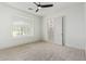 Bright bedroom with plush carpeting, a ceiling fan, and an en-suite bathroom at 2090 E Coconino Ct, Gilbert, AZ 85298