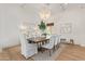 Elegant dining room features a large wooden table, chandelier, and hardwood floors at 2090 E Coconino Ct, Gilbert, AZ 85298