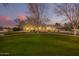 Elegant single-story home with a manicured lawn and mature trees at 2090 E Coconino Ct, Gilbert, AZ 85298