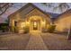 Evening view of the home's inviting entryway with brick details at 2090 E Coconino Ct, Gilbert, AZ 85298