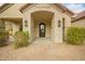 Elegant front entrance with brick columns and a dark-stained door at 2090 E Coconino Ct, Gilbert, AZ 85298