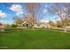 Spacious front yard with lush lawn and mature trees at 2090 E Coconino Ct, Gilbert, AZ 85298