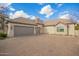 Two-car garage with a brick facade and large driveway at 2090 E Coconino Ct, Gilbert, AZ 85298