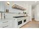 Modern kitchen features white cabinets and a high-end range at 2090 E Coconino Ct, Gilbert, AZ 85298