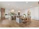 Modern kitchen with light wood cabinets, island, and dining area at 2090 E Coconino Ct, Gilbert, AZ 85298