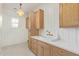 Charming laundry room with light wood cabinets, a farmhouse sink, and window at 2090 E Coconino Ct, Gilbert, AZ 85298