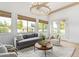 Relaxing sitting room features a gray sofa, wood coffee table, and access to backyard at 2090 E Coconino Ct, Gilbert, AZ 85298