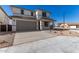 Two-story house with gray garage door and desert landscaping at 31730 N Waddle Ln, San Tan Valley, AZ 85143