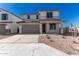 Two-story house with gray garage door and desert landscaping at 31730 N Waddle Ln, San Tan Valley, AZ 85143