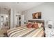 Striped bed in a bedroom with wood headboard and access to another room at 3236 E Chandler Blvd # 2033, Phoenix, AZ 85048