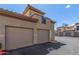 Attached garage with tan door and exterior of building at 3236 E Chandler Blvd # 2033, Phoenix, AZ 85048