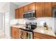 Well-equipped kitchen with granite countertops and stainless steel appliances at 3236 E Chandler Blvd # 2033, Phoenix, AZ 85048