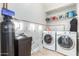 Bright laundry room with washer, dryer, and shelving at 3236 E Chandler Blvd # 2033, Phoenix, AZ 85048